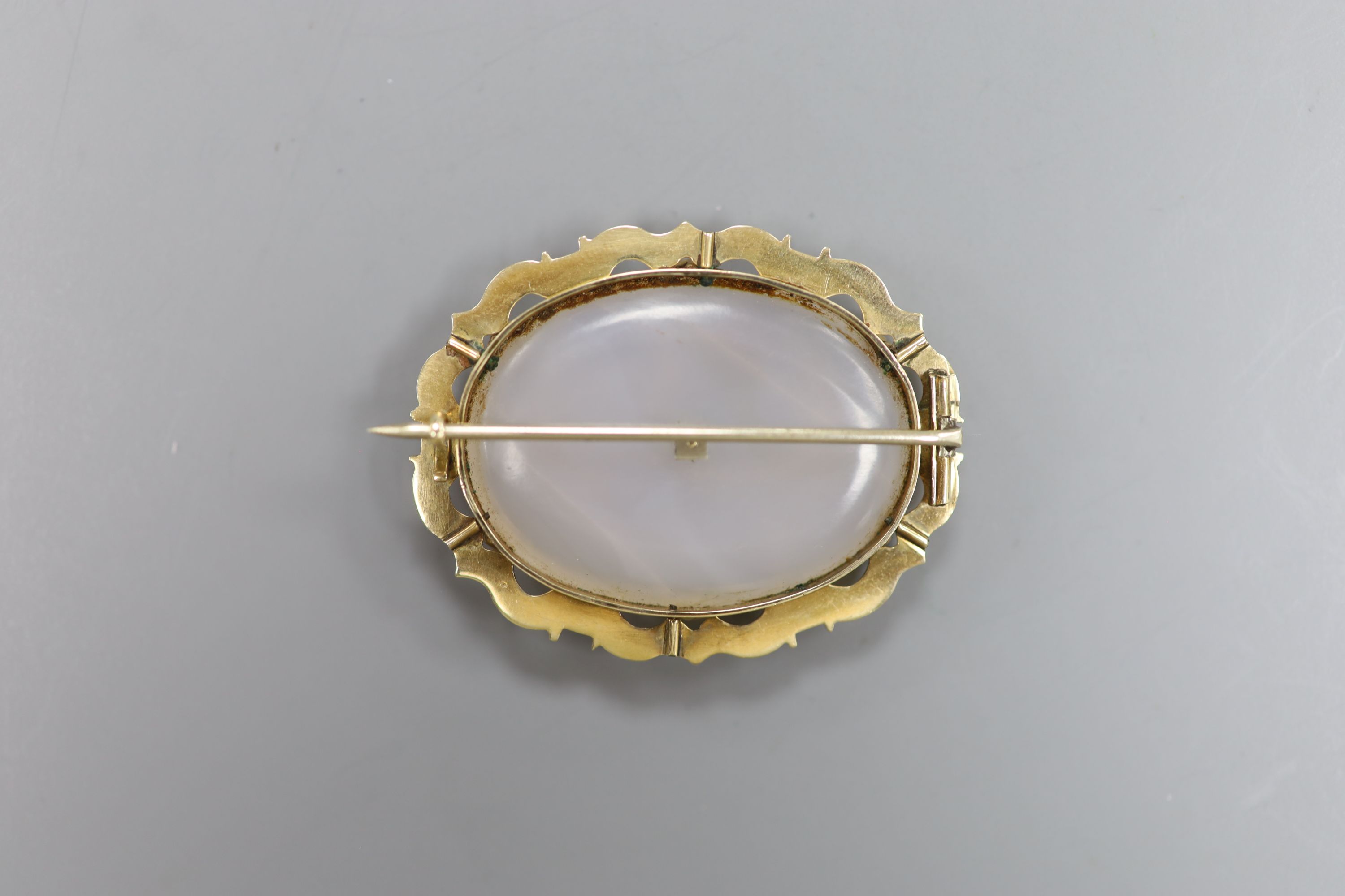 An early 20th century yellow metal mounted, white chalcedony and turquoise set oval brooch, 44mm, gross 15.1 grams